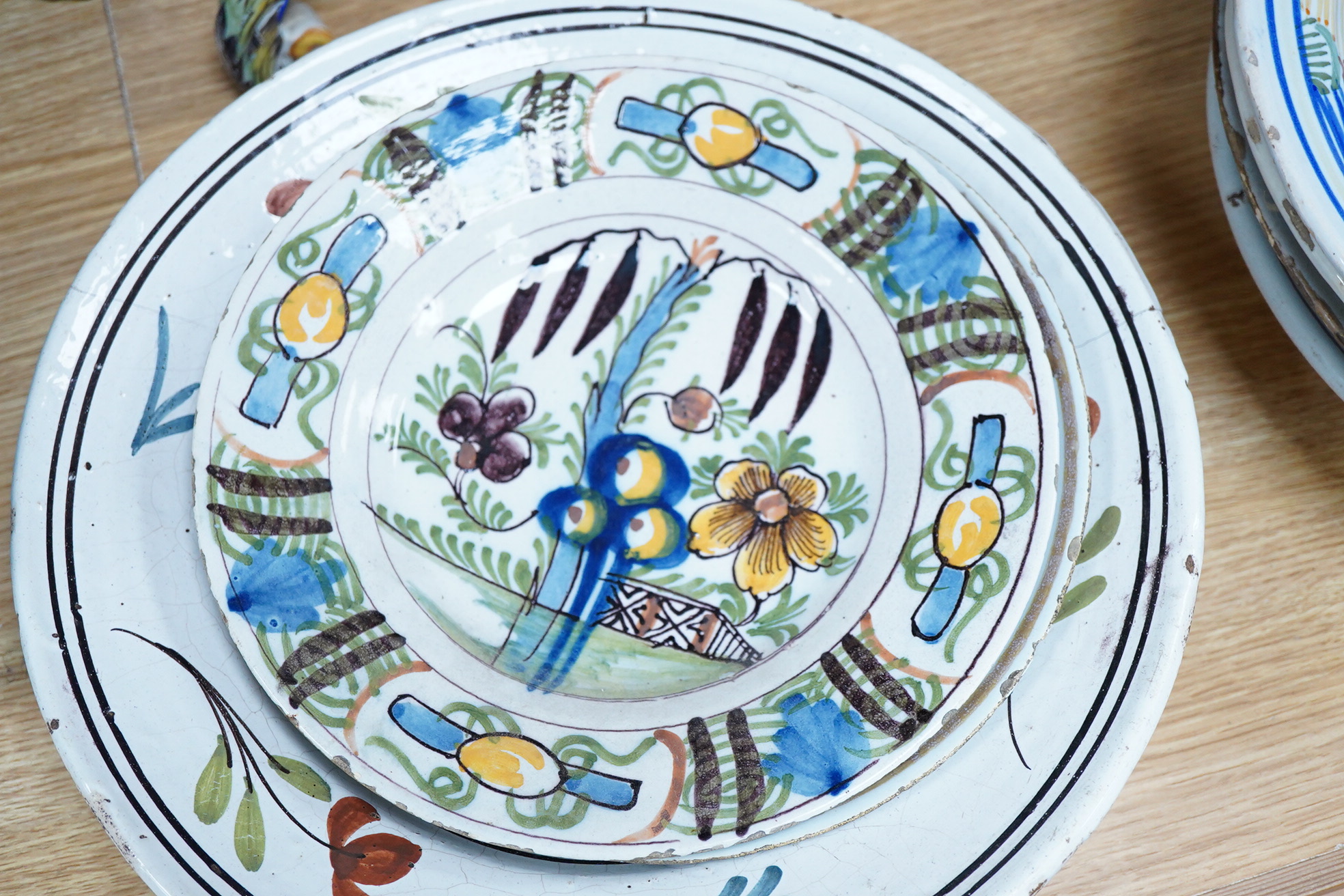 18th and 19th century faience including five chargers and large bowl, latter 30cm